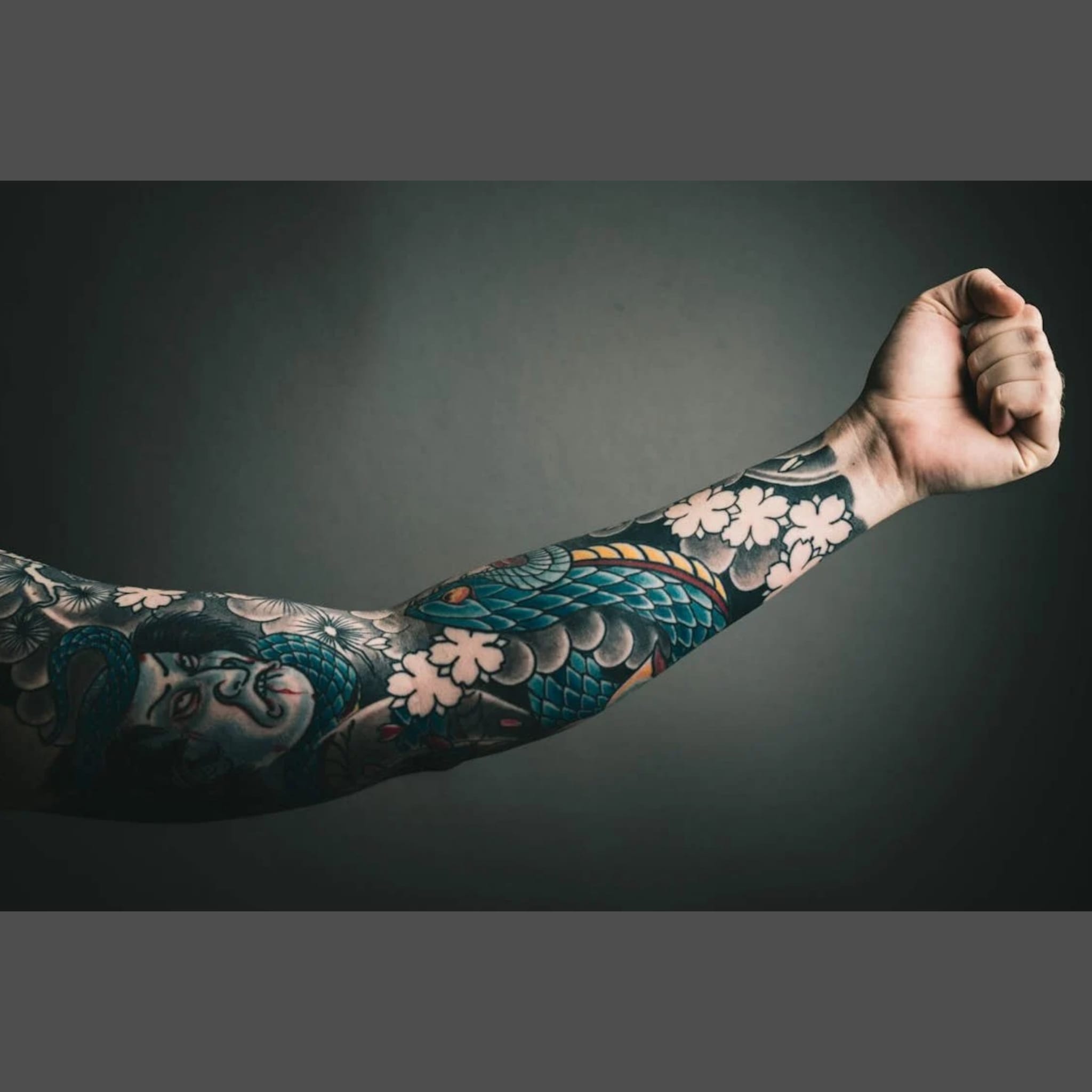 Colourful japanese koi tattoo with black waves background